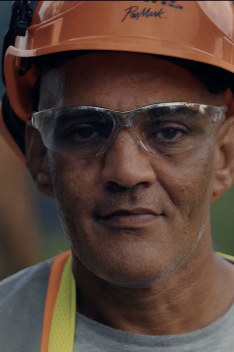A Team Rubicon volunteer in an orange hard hat.