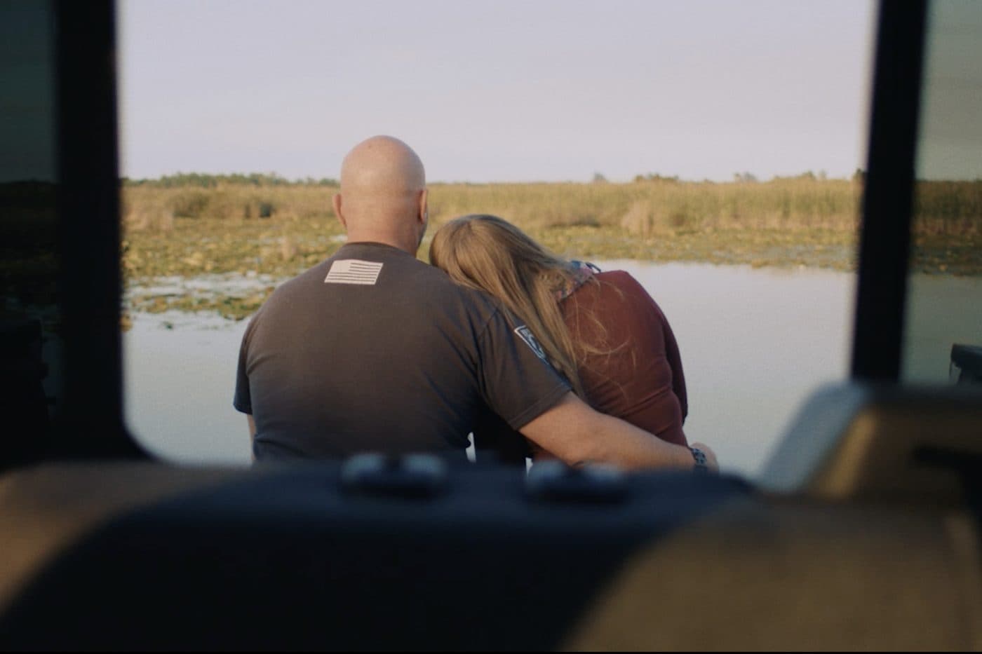 Dean and Ginna on the tailgate, looking out over the water.