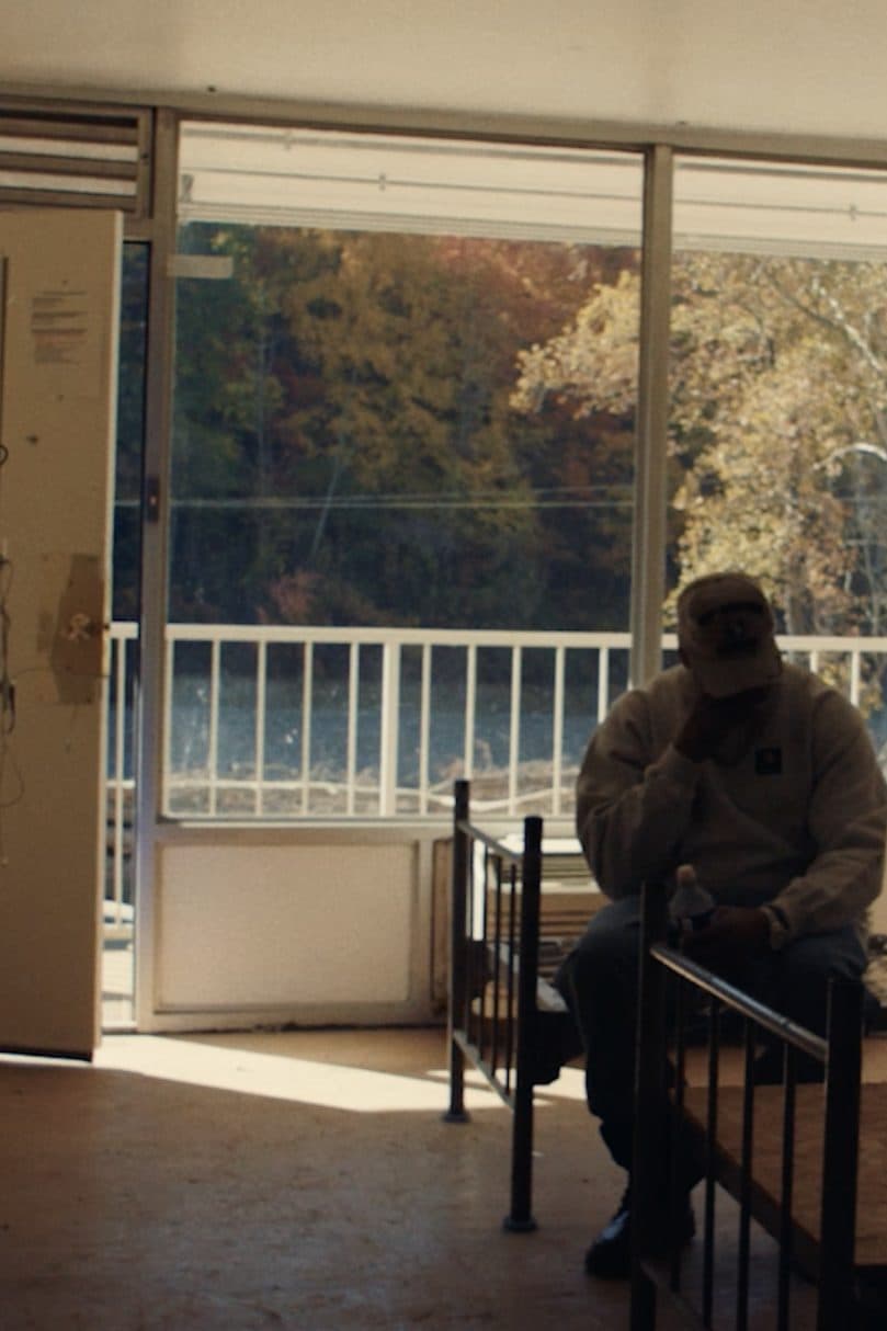 A man sitting alone in a stripped-out room at the Veterans Restoration Quarters.