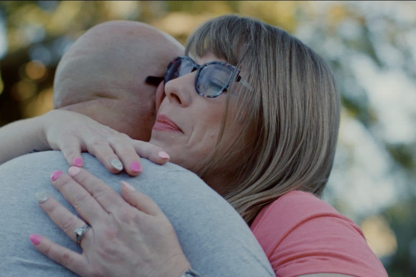 Dean and Ginna in an embrace.