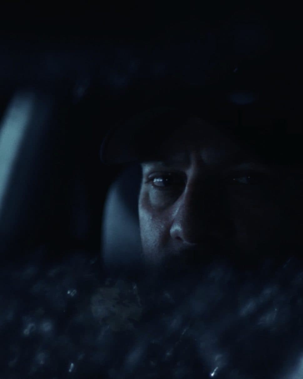A face in the dark, lit by a screen.