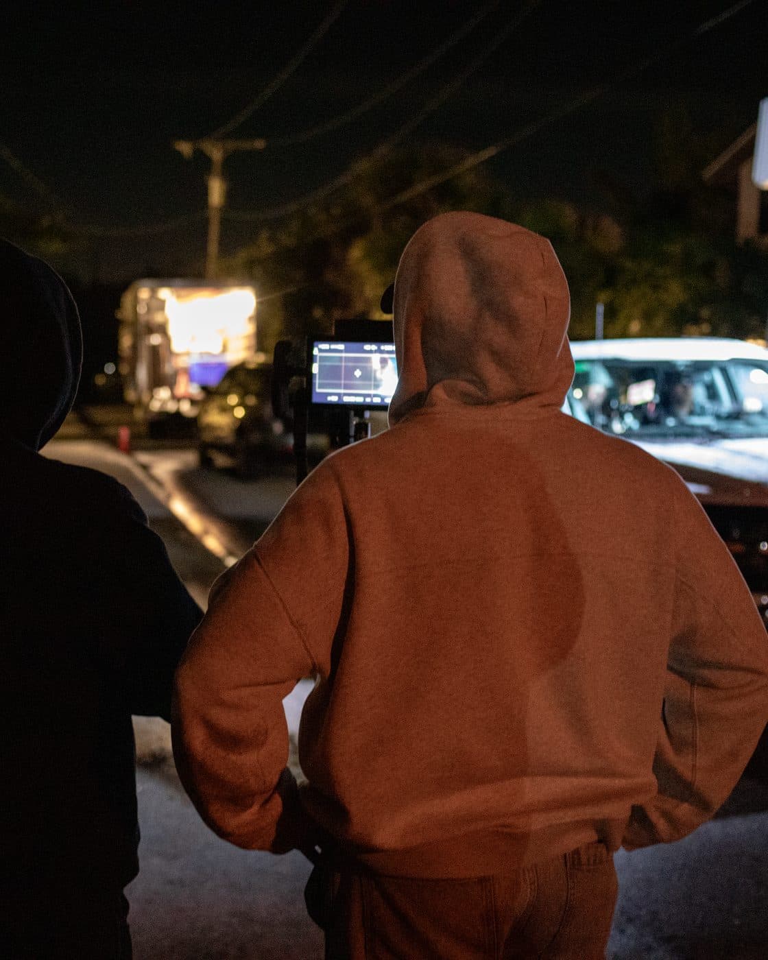 The crew filming at night under lights.