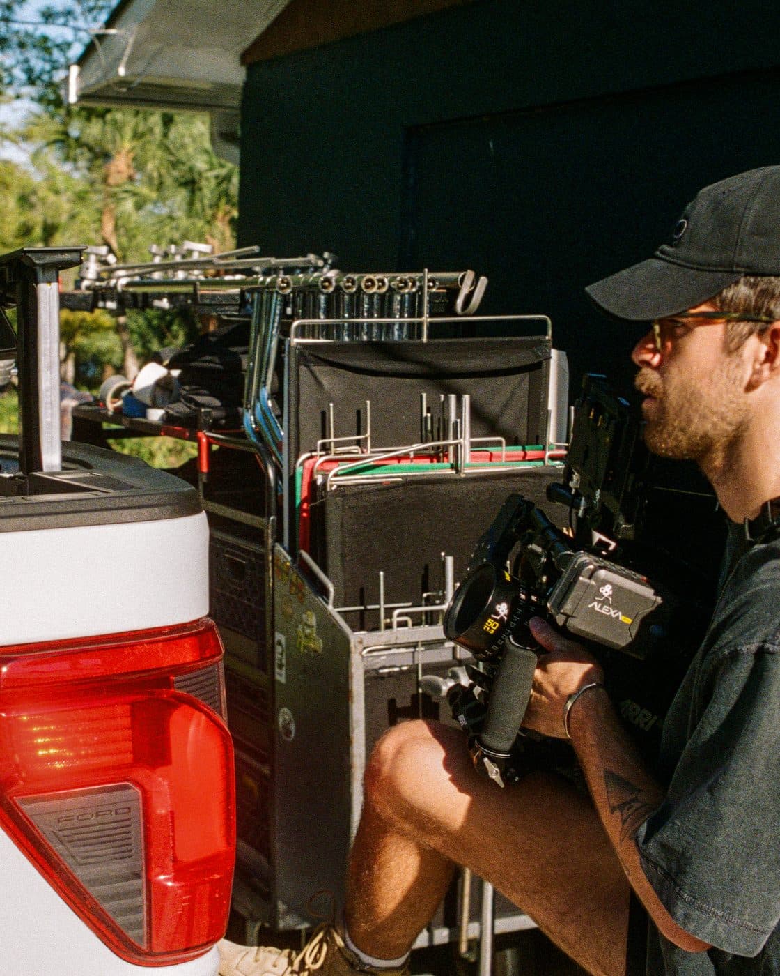 A camera operator at the back of a truck.