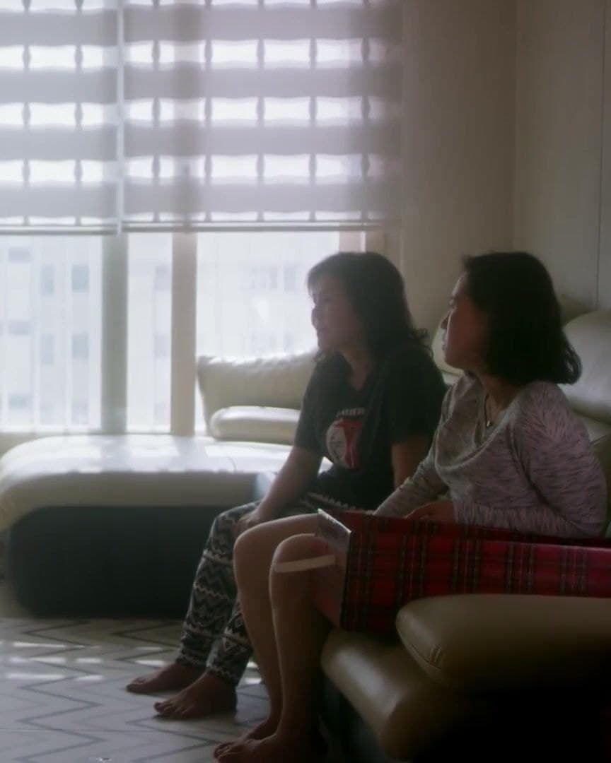 Two women on a sofa by a window in Seoul.