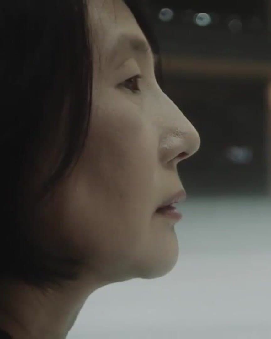 A woman in profile at the rink.