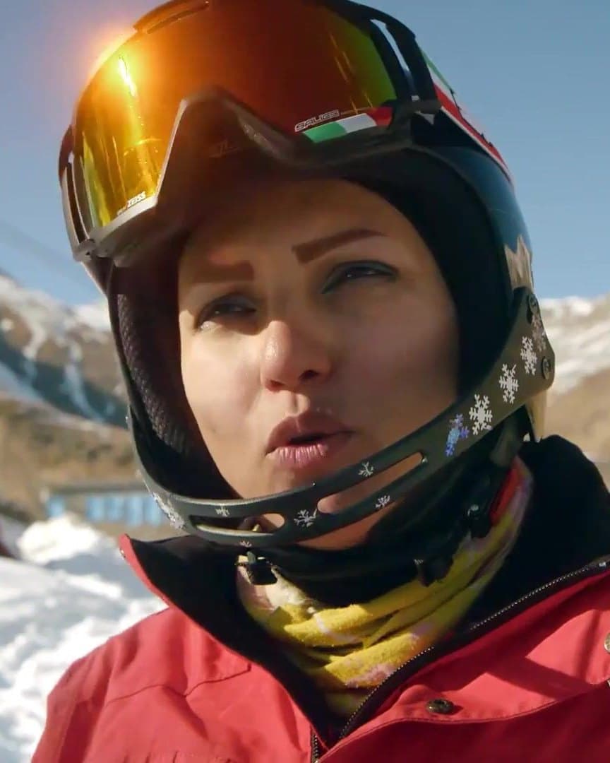 A skier in helmet and goggles on the mountain.