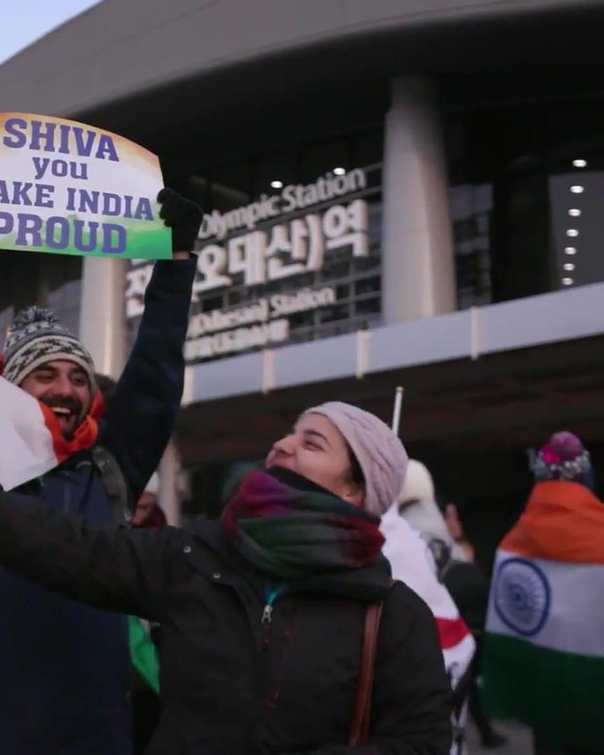 Fans holding a “Make India Proud” banner.