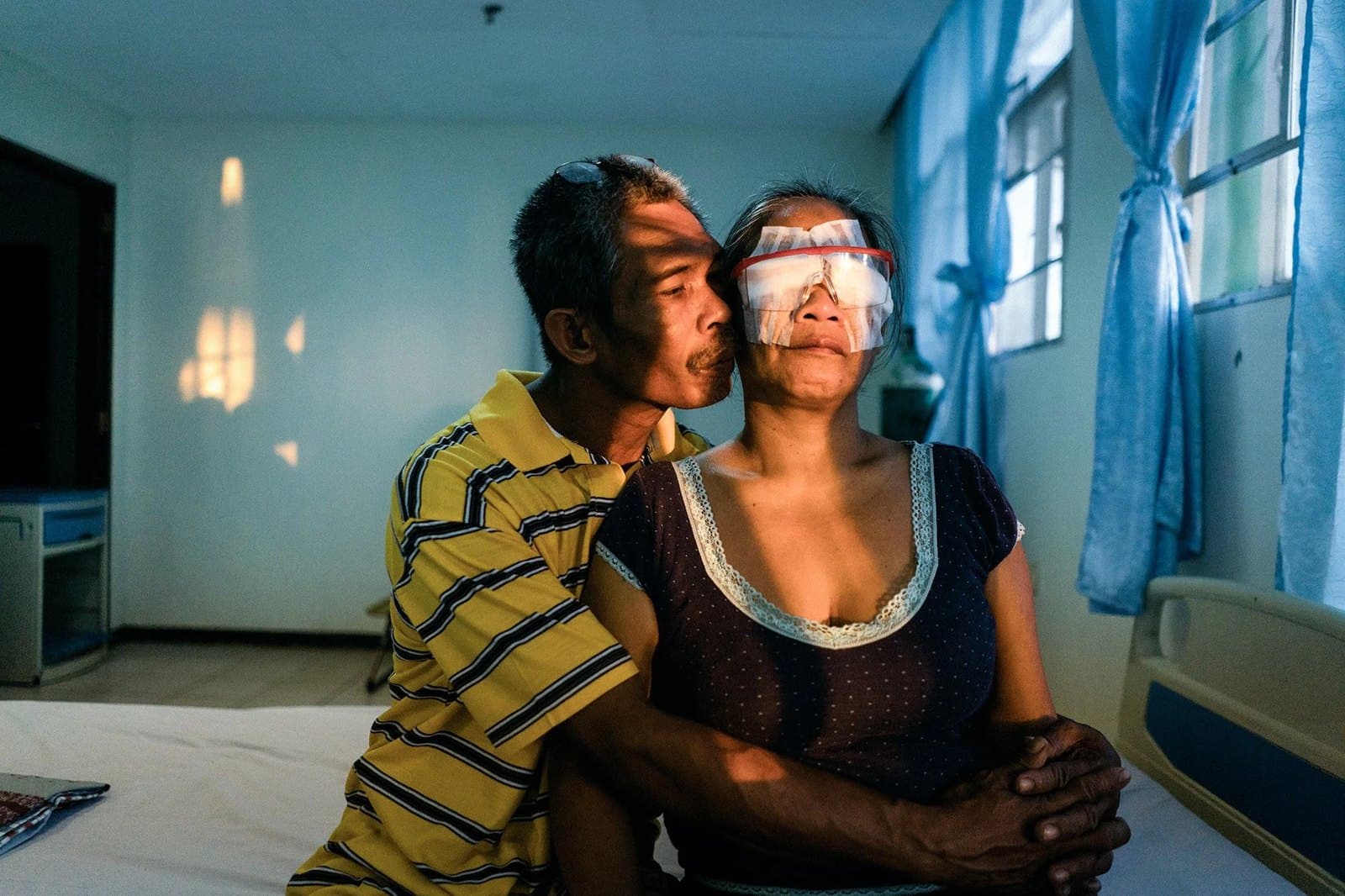 Virgilio kissing Joanaly’s cheek, her eyes bandaged after surgery.