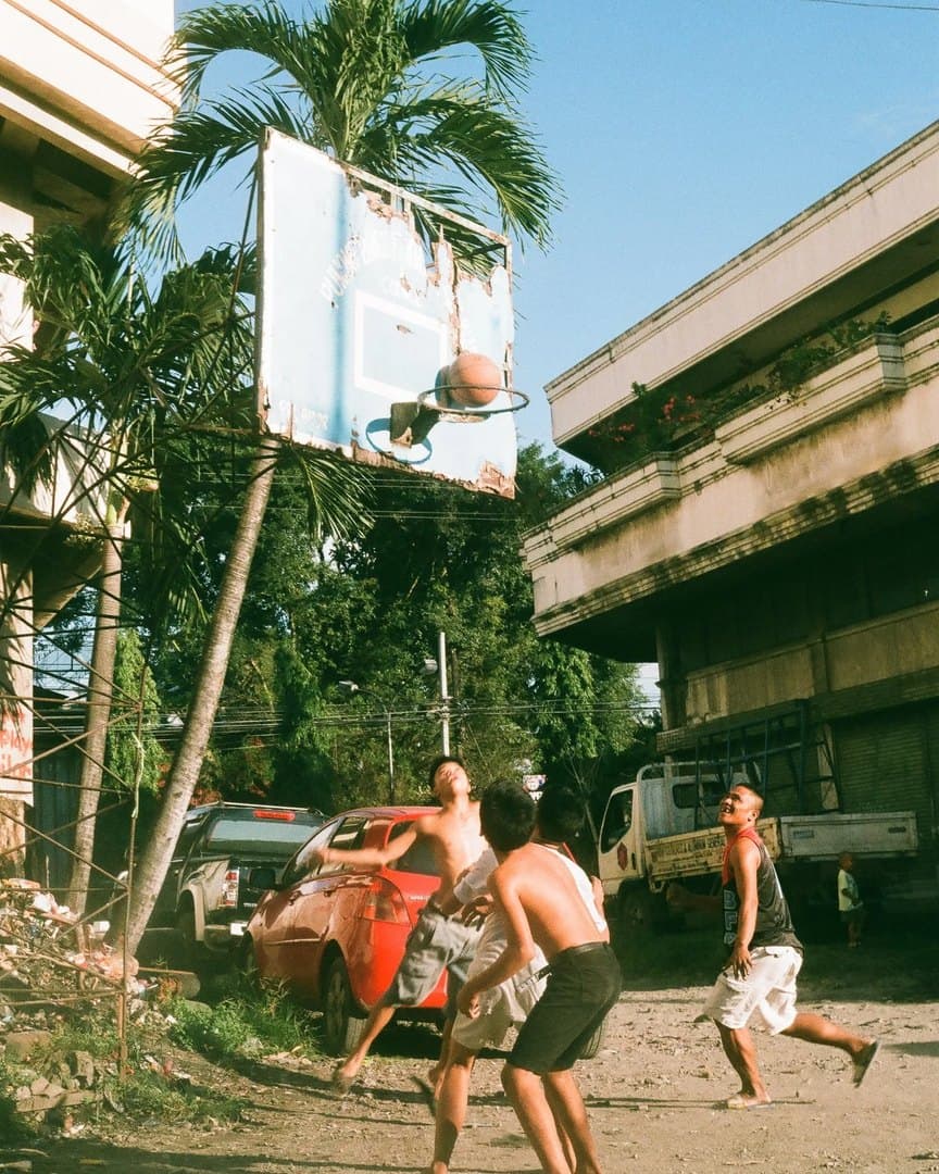 Kids playing basketball outside the hospital, on 35mm.