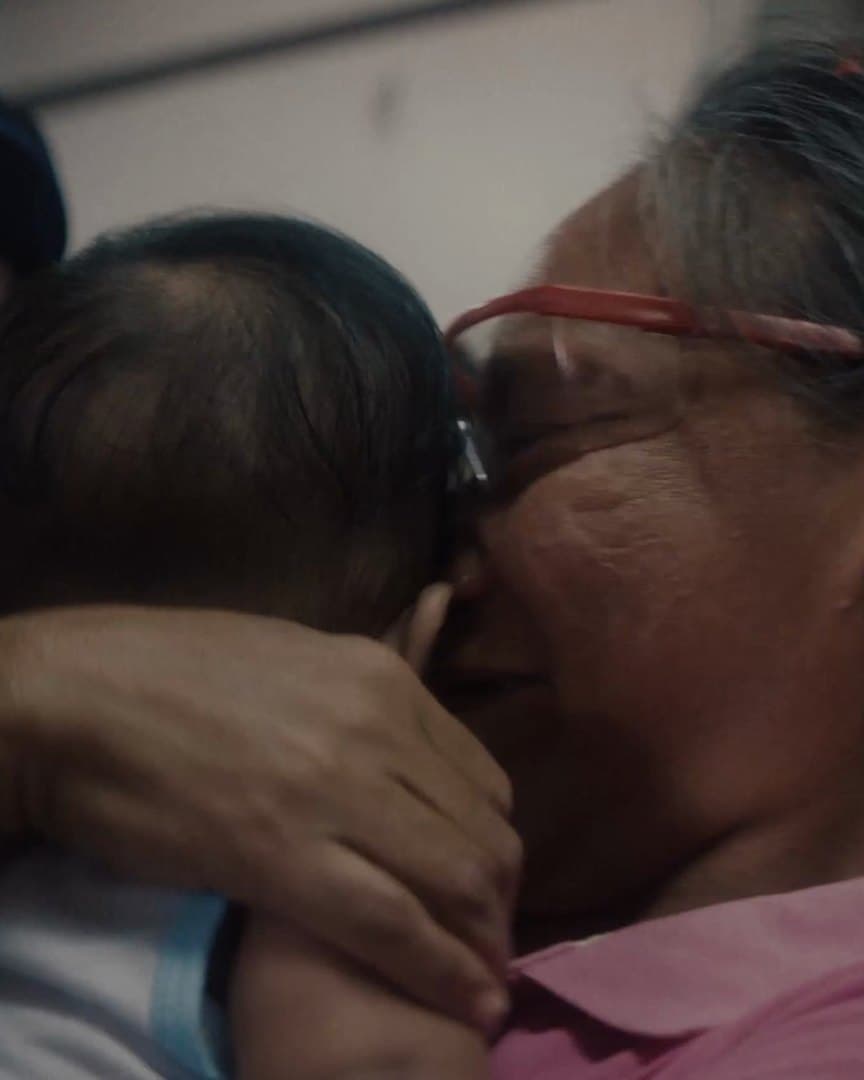 Joanaly holding her grandchild after surgery.