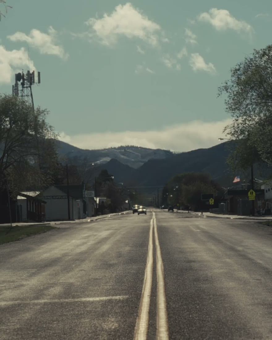 An empty highway running out toward mountains.