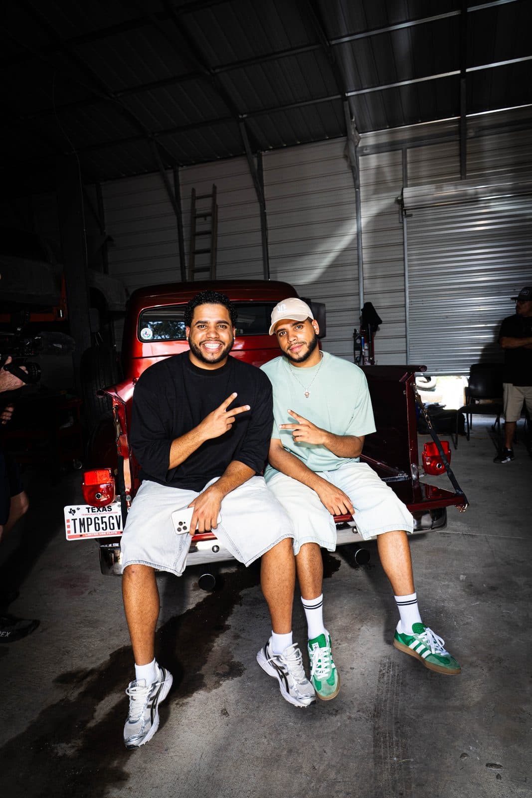 The twins on the back of a classic truck in a Dallas garage.