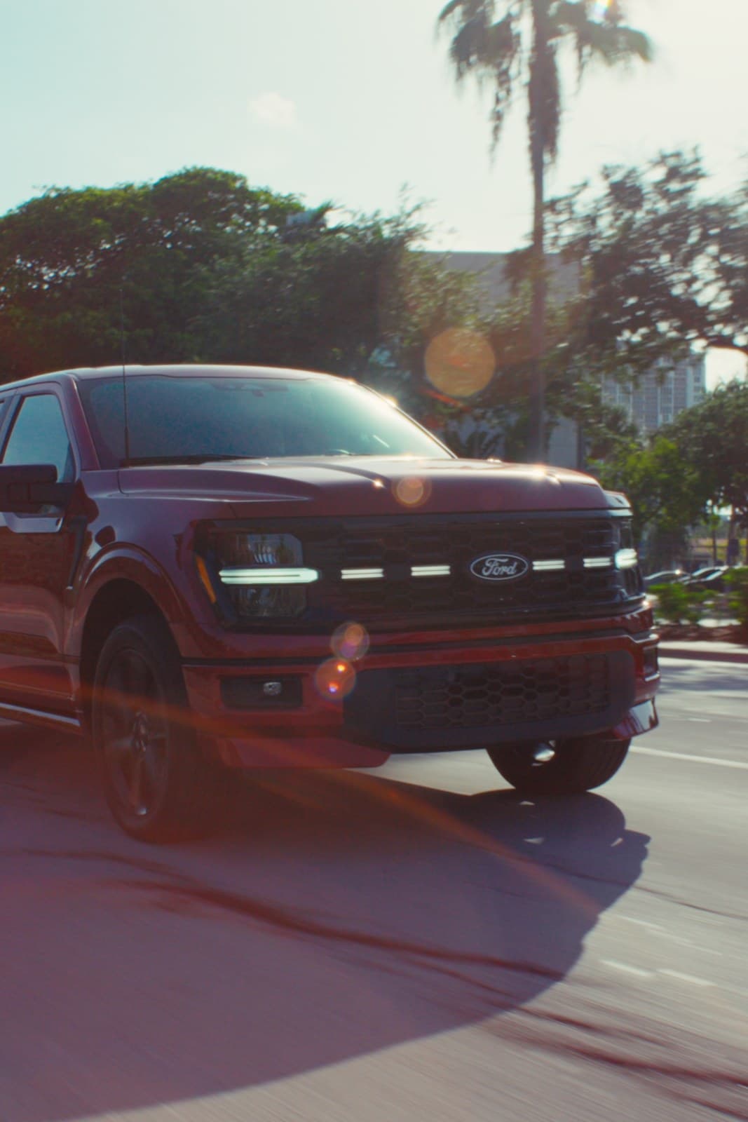 The red F-150 on a Miami street, sun flaring off the grille.