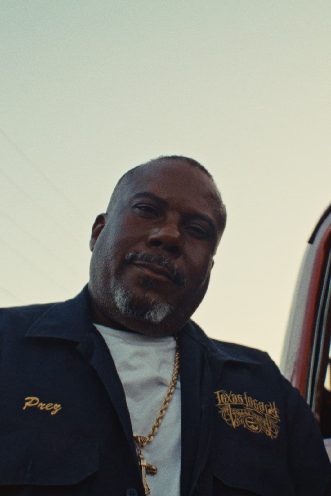 A Dallas lowrider club member beside his truck.