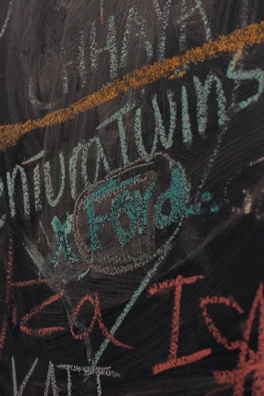 “Ventura Twins x Ford” chalked on a wall of signatures.