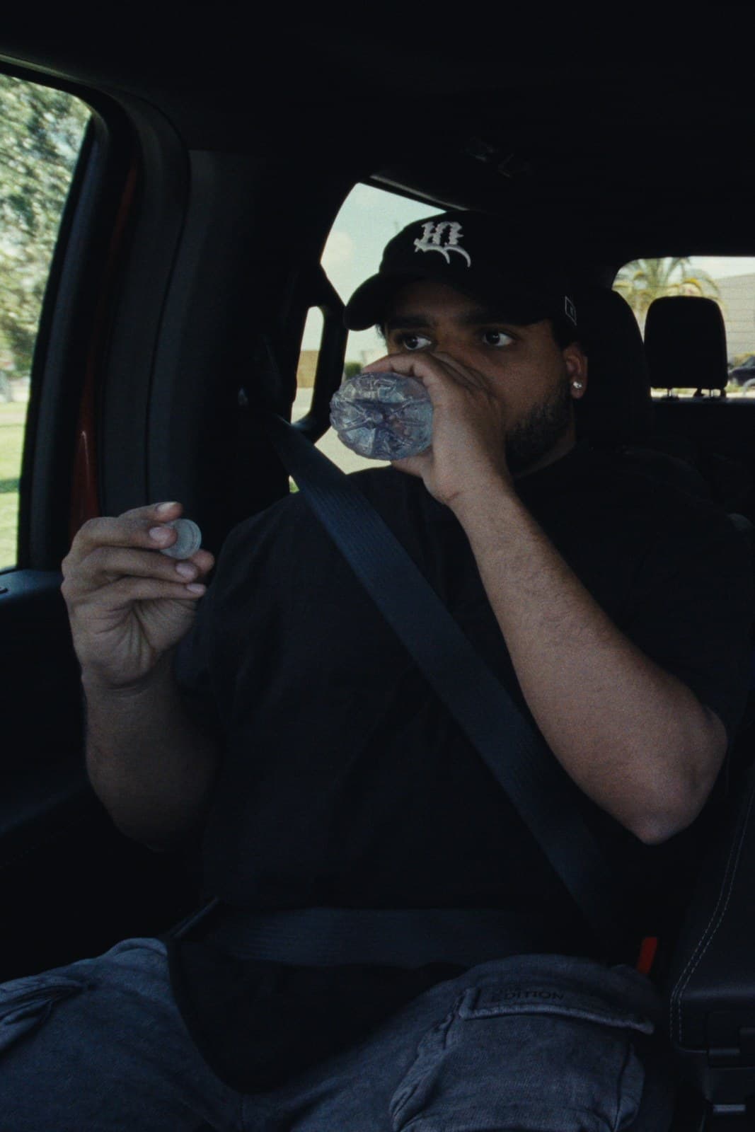 One of the twins taking a drink of water in the cab.