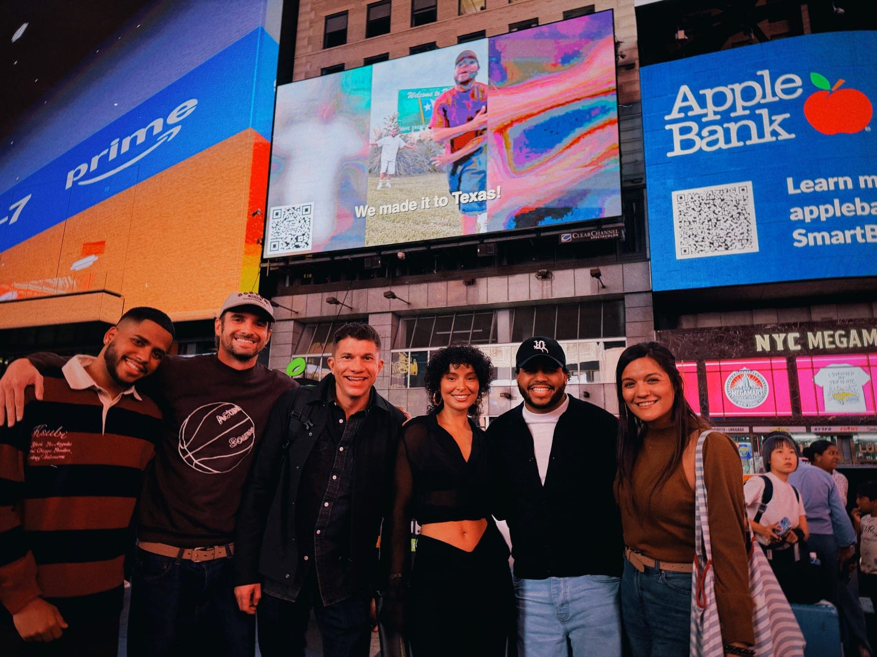 The Ventura Twins and the team in Times Square under the 1560 Broadway screen as the La Caravana spot plays.