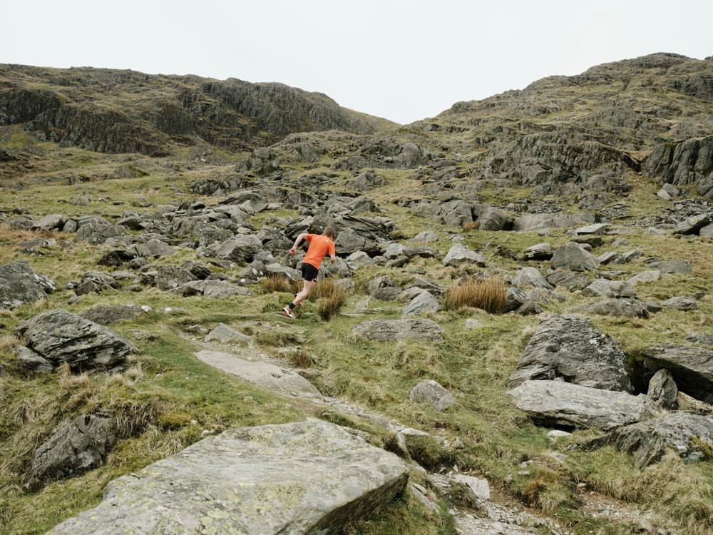 A runner picking a line through boulders.
