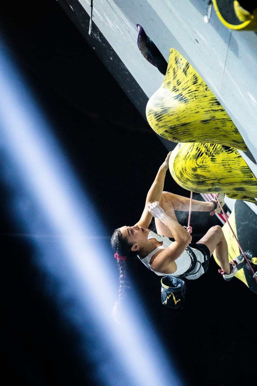 A climber on yellow volumes, cut by a beam of light.