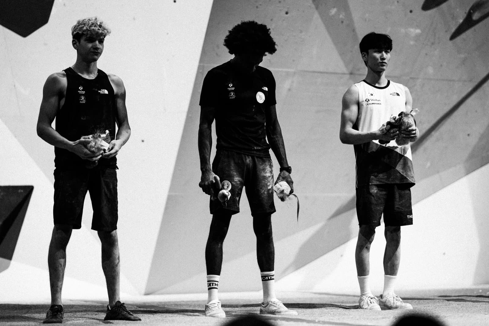 Three climbers side by side, in black and white.