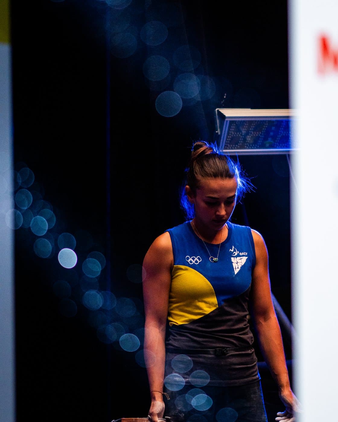 A climber in the dark before her turn.