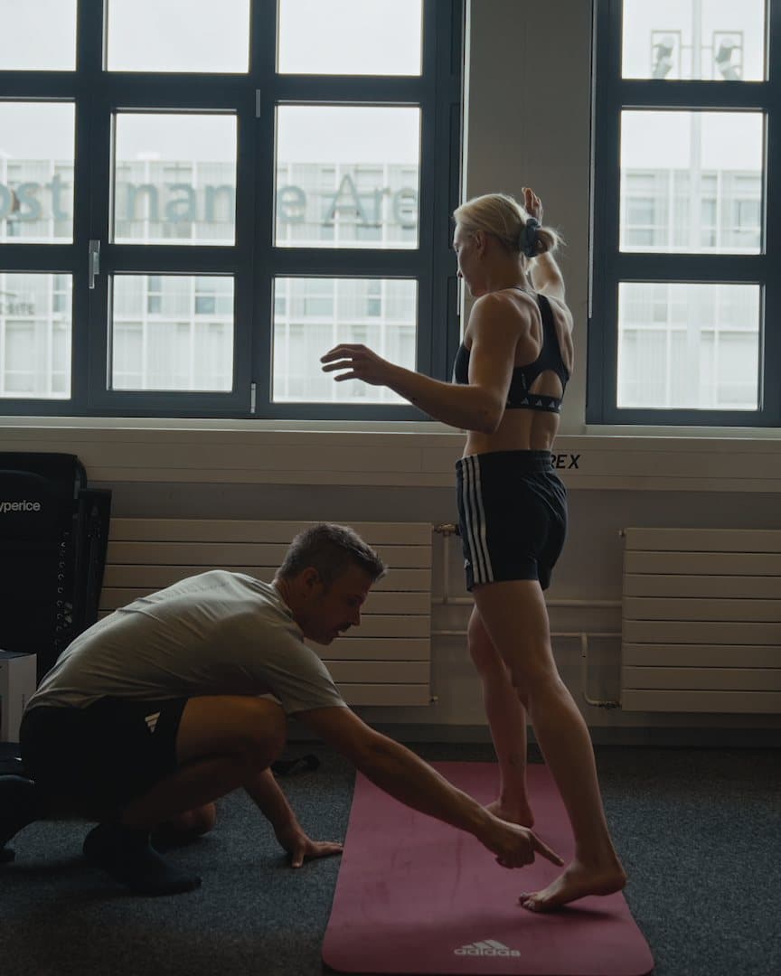 A physio working with a climber in the warm-up room.