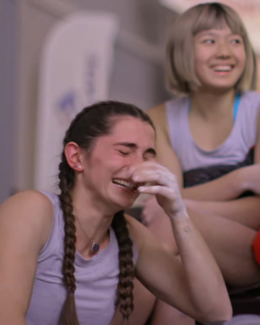 Two young climbers in tears together.