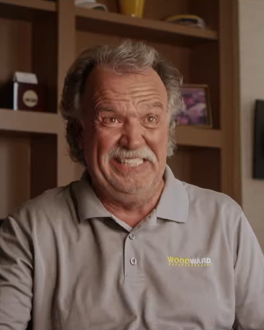 A surf official laughing in his office.