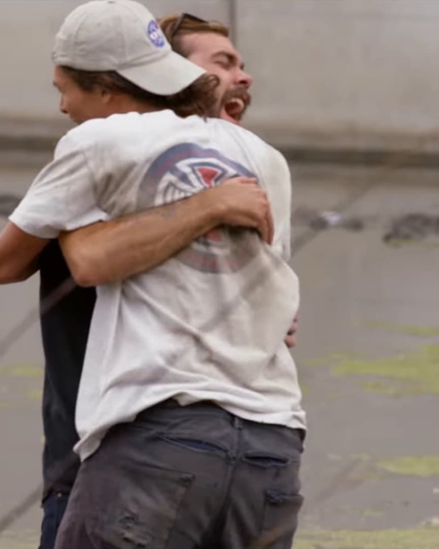 Two skaters hugging.