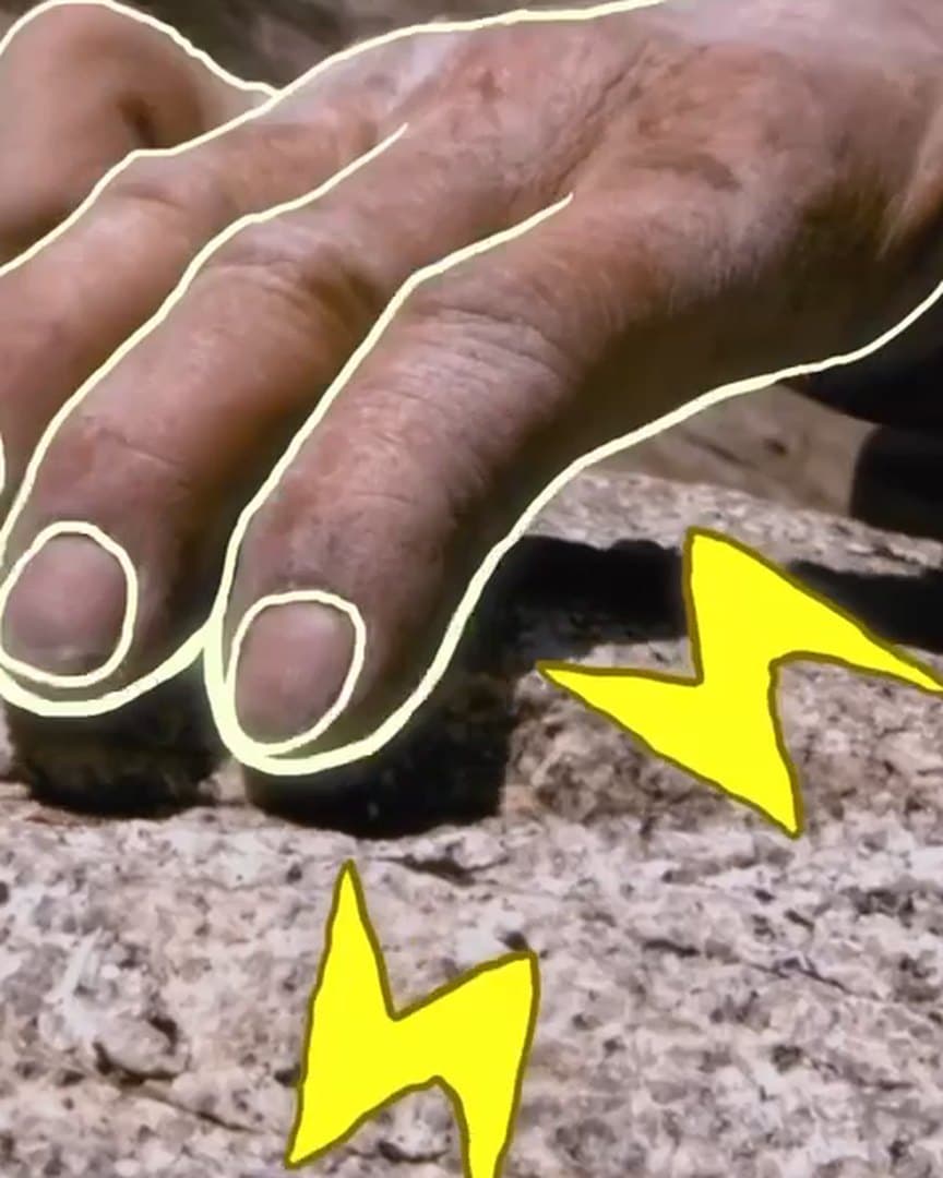 An animated hand gripping a climbing hold.