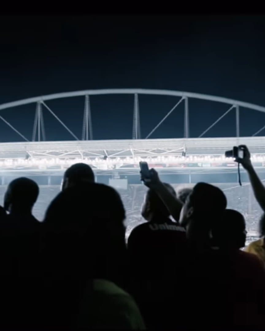 A crowd watching a contest at night.