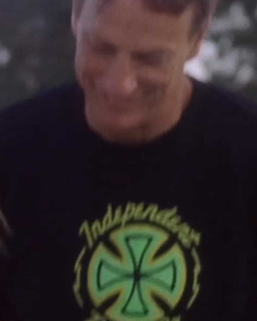 Tony Hawk laughing with a young skater.