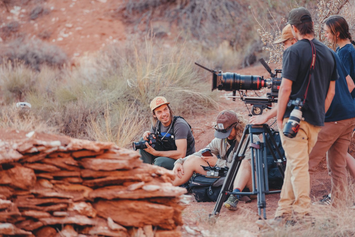 Camera crew working on red rock