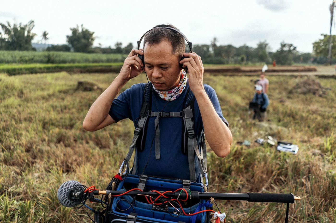 Sound recordist listening back in the field