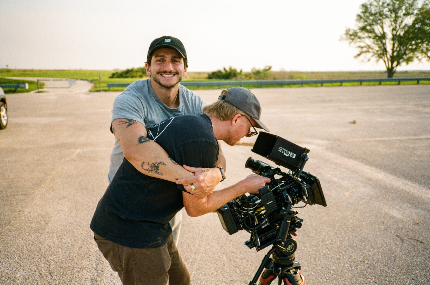 Two crew laughing behind the camera