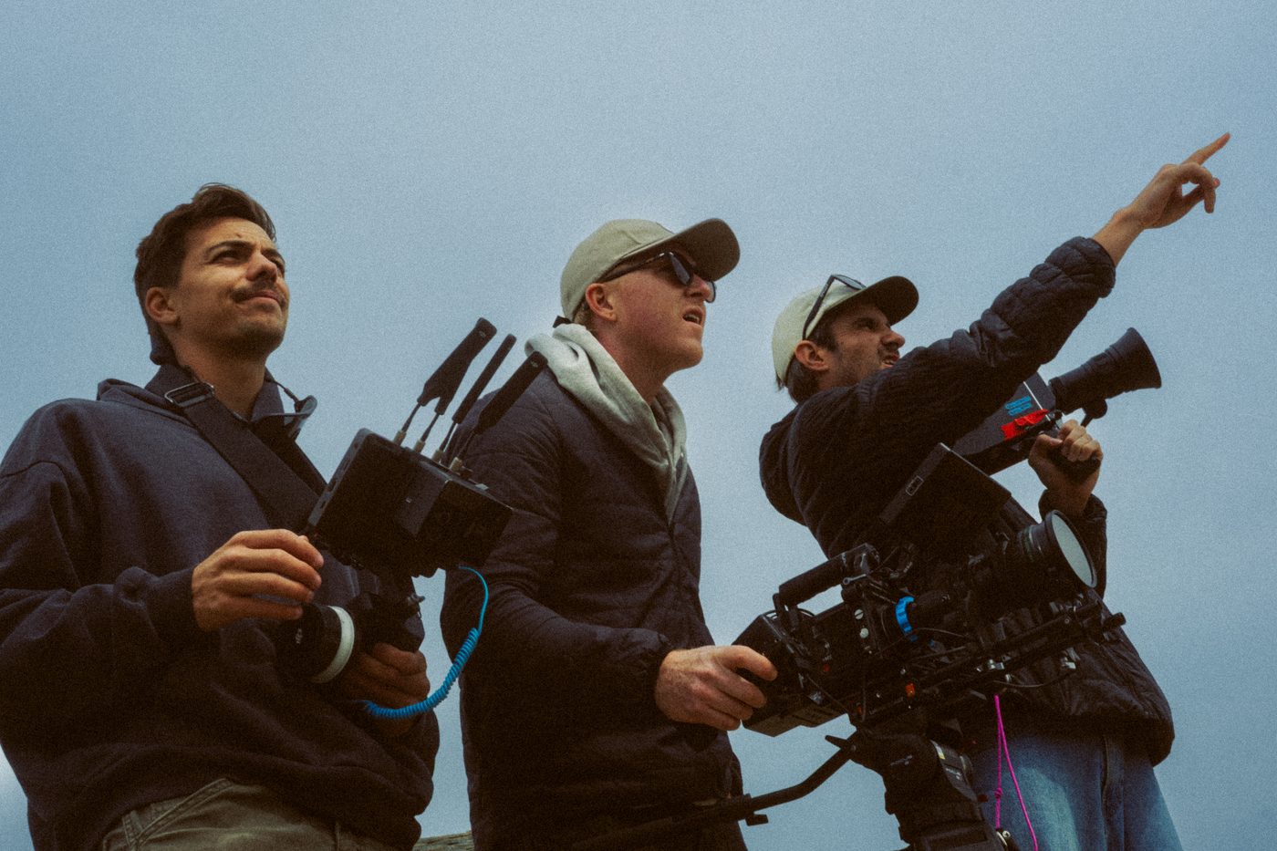 Crew pointing out the shot against open sky