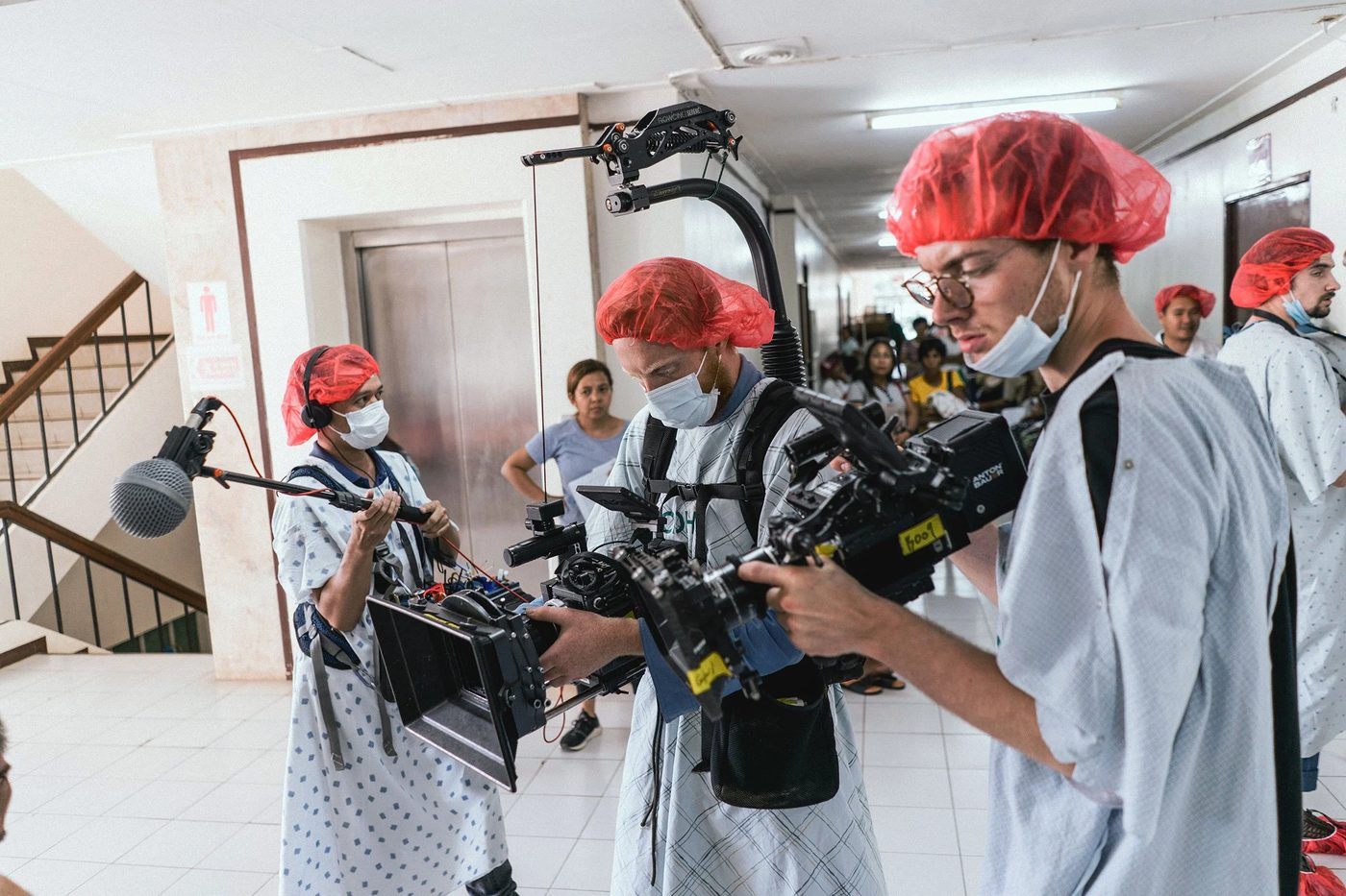 Crew moving through a hospital corridor